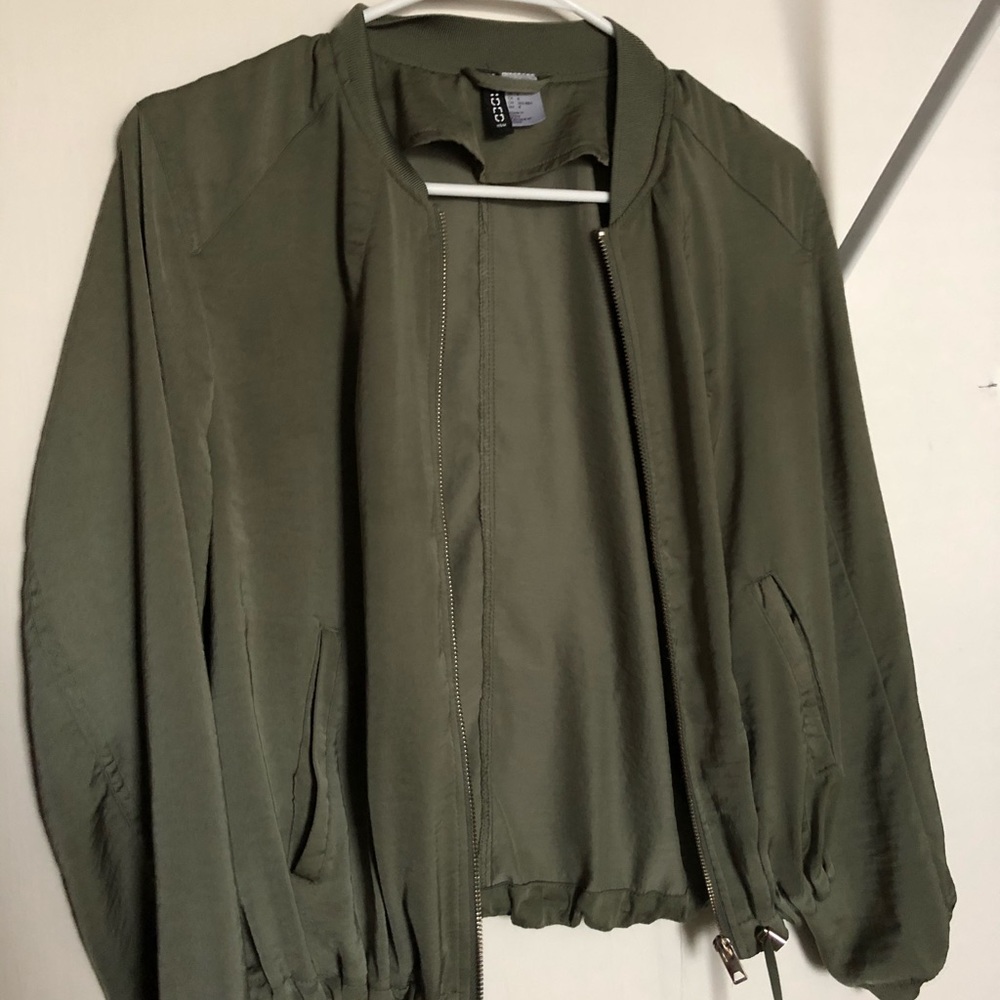 Thin green jacket with gold zipper.